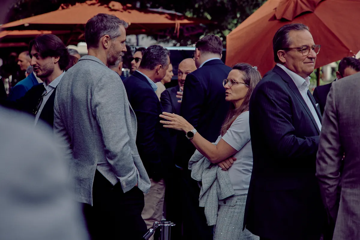 Executives networking in the street in front of the venue