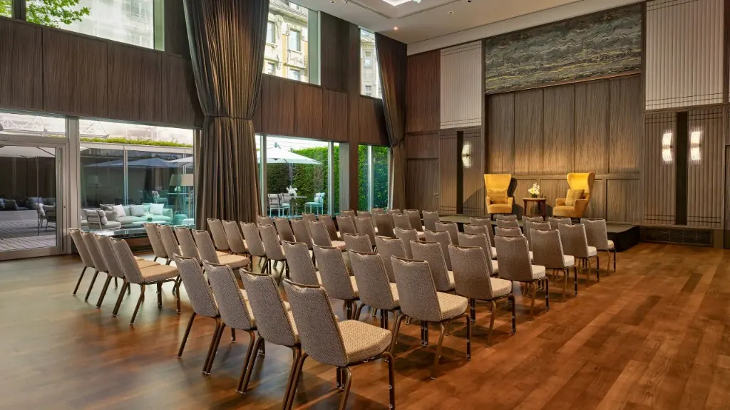 Bright ballroom with rows of chairs and garden view at the Park Hyatt Zurich